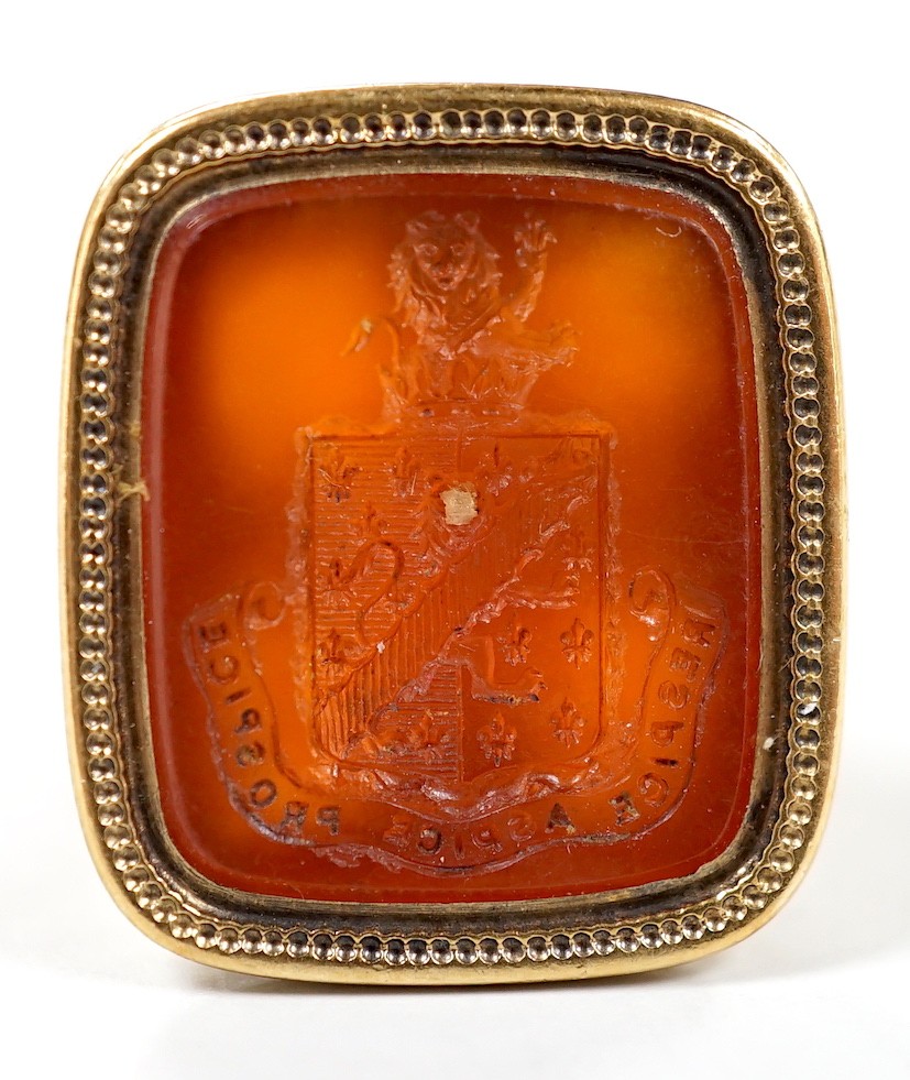 An early 19th century yellow metal overlaid and carnelian set fob seal, the matrix carved with armorial, 29mm.